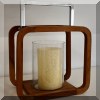 D09. Teak and glass candle stand. 
